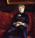 woman sitting on a red flowered sofa