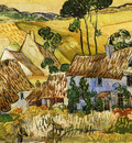 thatched houses against a hill