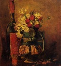 vase with carnations and roses and a bottle
